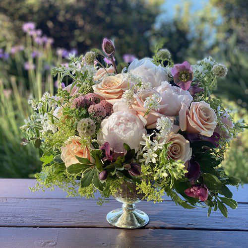 Garden roses peonies and hellebores in a silver compote vase, luxury florist Raleigh NC